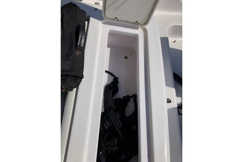 Slide: The Image of Open storage compartment on 2005 Donzi 35 ZF Daytona boat, containing ropes and a black bag. - 42
