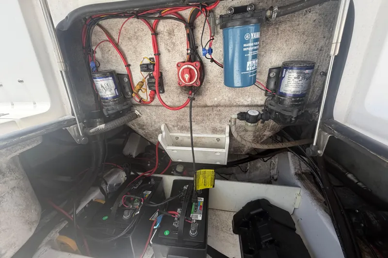 Slide: The Image of 2015 Sportsman Heritage 231 Center Console boat wiring and battery compartment. - 14