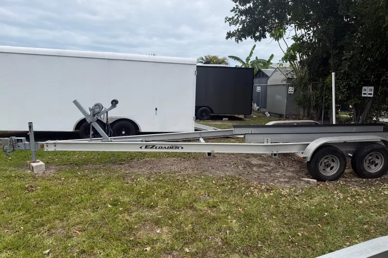 Slide: The Image of Trailer for 2015 Sportsman Heritage 231 Center Console, parked on grass. - 16