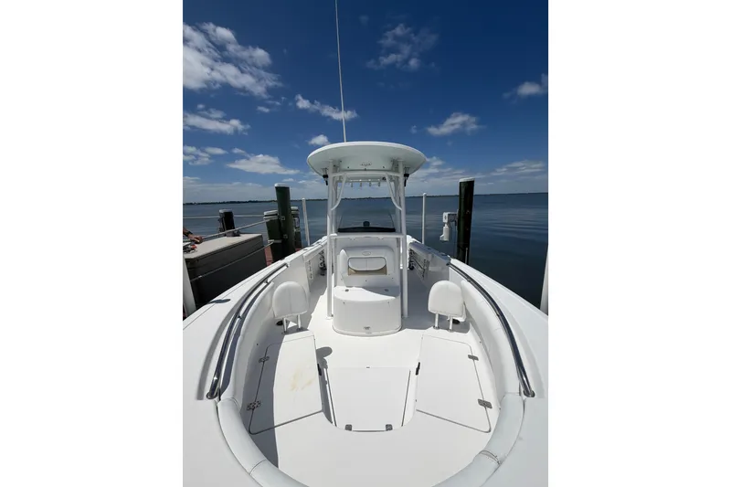 Slide: The Image of 2015 Sportsman Heritage 231 Center Console boat docked under clear blue sky. - 6