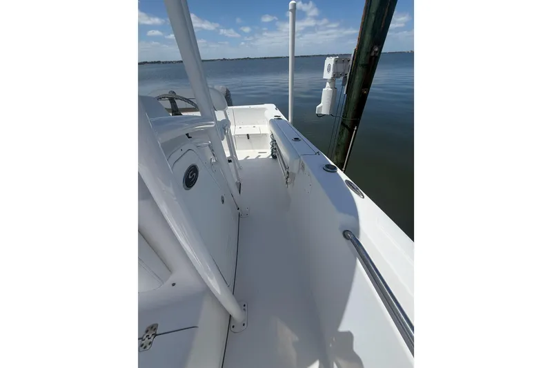 Slide: The Image of 2015 Sportsman Heritage 231 Center Console boat docked on calm water. - 7