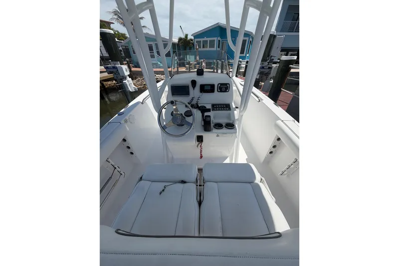 Slide: The Image of 2015 Sportsman Heritage 231 Center Console boat interior with steering wheel and controls. - 8