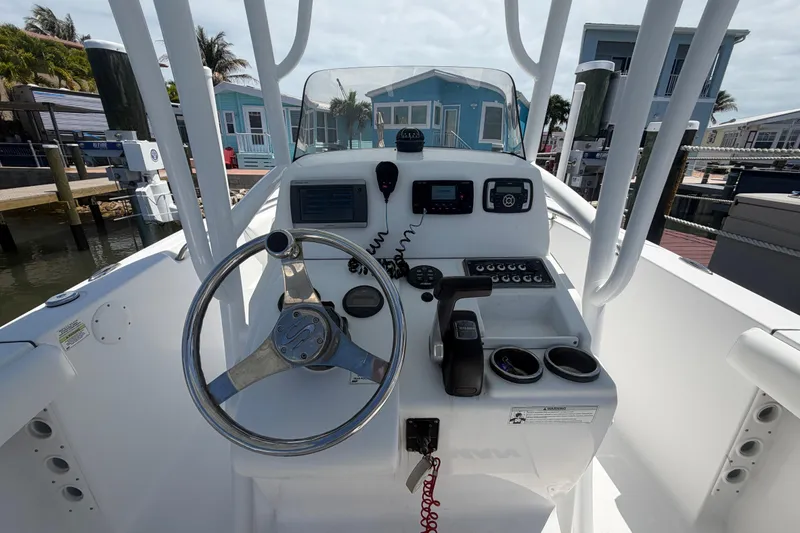 Slide: The Image of 2015 Sportsman Heritage 231 Center Console boat helm with steering wheel and controls. - 9