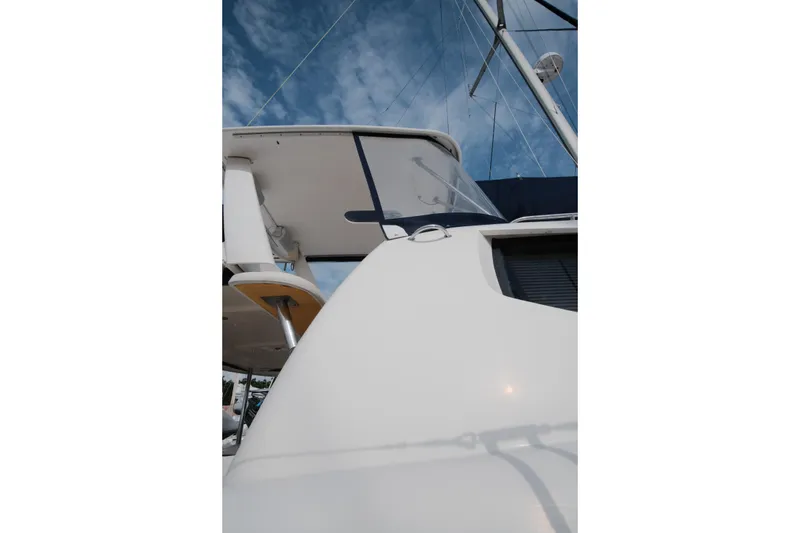 Slide: The Image of Leopard 46 yacht, 2007 model, showcasing sleek design and modern architecture against a blue sky. - 12