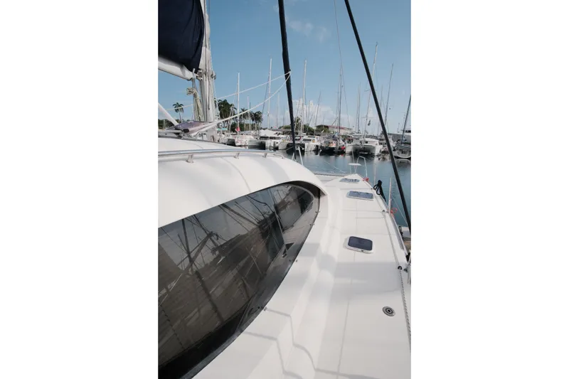 Slide: The Image of 2007 Leopard 46 yacht docked in a marina, showcasing sleek design and spacious deck. - 15