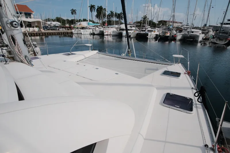 Slide: The Image of Leopard 46 catamaran docked in marina, showcasing spacious deck and surrounding boats. - 16