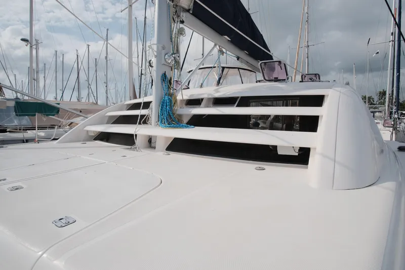 Slide: The Image of 2007 Leopard 46 catamaran deck with ropes and hatches in a marina setting. - 20