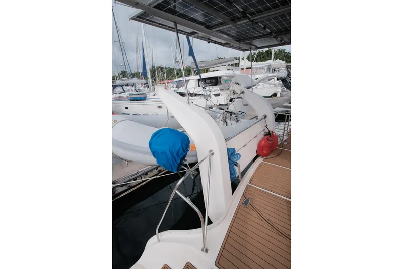 Slide: The Image of 2007 Leopard 46 yacht docked, featuring solar panels and a dinghy on deck. - 37