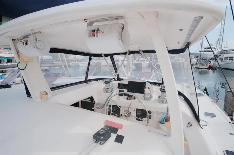 Slide: The Image of Cockpit of a 2007 Leopard 46 yacht, featuring navigation equipment and marina view. - 40