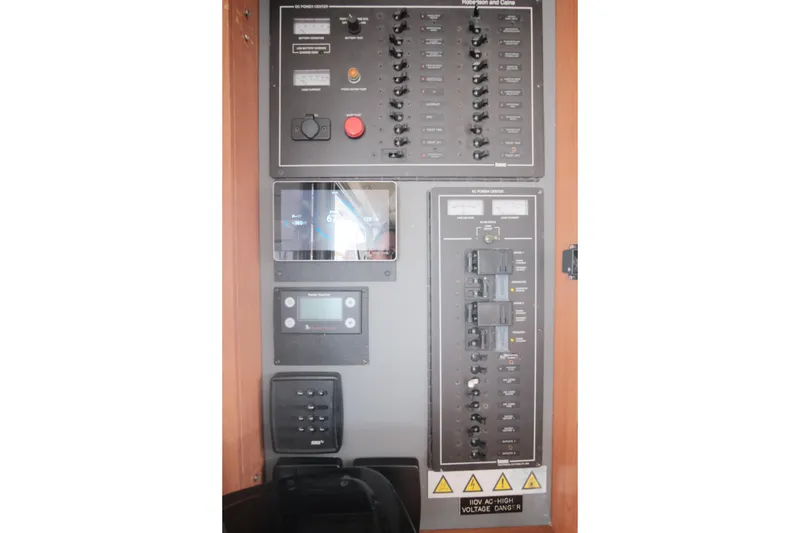 Slide: The Image of Electrical control panel on a 2007 Leopard 46 yacht, featuring various switches and displays. - 41
