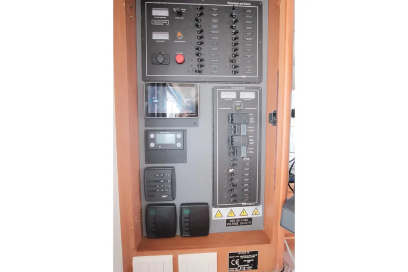 Slide: The Image of Electrical control panel on a 2007 Leopard 46 yacht, featuring various switches and displays. - 42