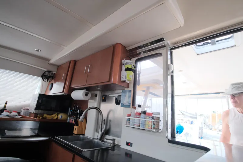 Slide: The Image of Interior of 2007 Leopard 46 yacht kitchen with cabinets, sink, and window view. - 43