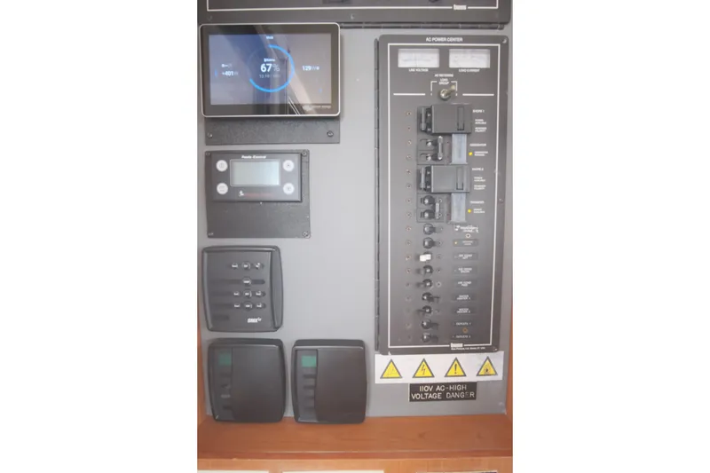 Slide: The Image of Electrical control panel on a 2007 Leopard 46 yacht, featuring various switches and displays. - 51