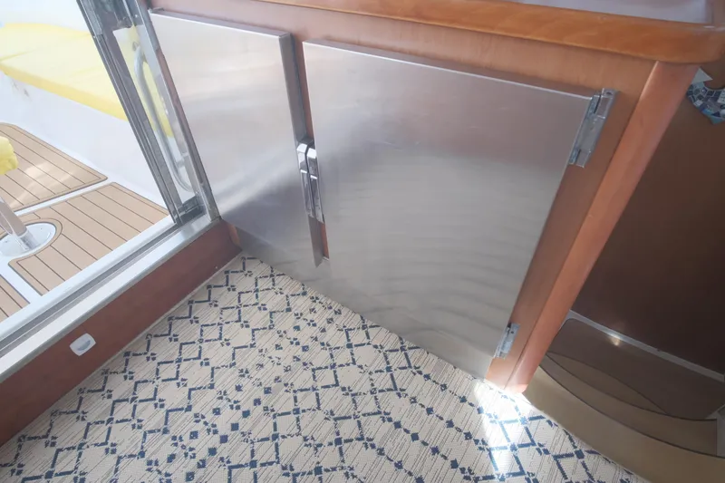 Slide: The Image of Stainless steel cabinet doors on 2007 Leopard 46 yacht with patterned carpet flooring. - 52