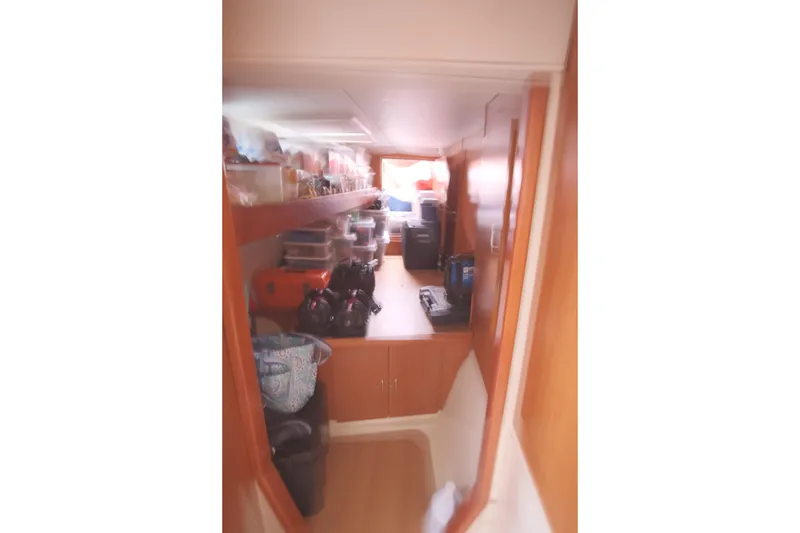 Slide: The Image of Interior storage area of a 2007 Leopard 46 yacht, featuring shelves and cabinets. - 53