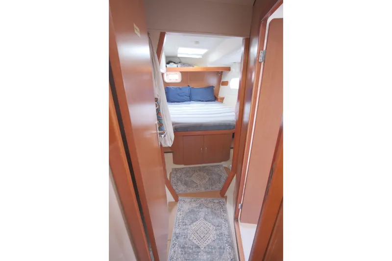 Slide: The Image of Cozy cabin interior of 2007 Leopard 46 yacht with bed and wooden furnishings. - 55
