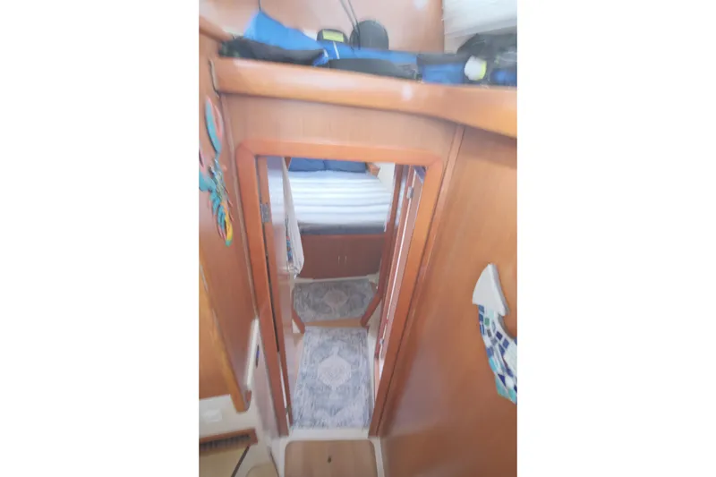 Slide: The Image of Interior view of a 2007 Leopard 46 yacht cabin with wooden finish and decor. - 58