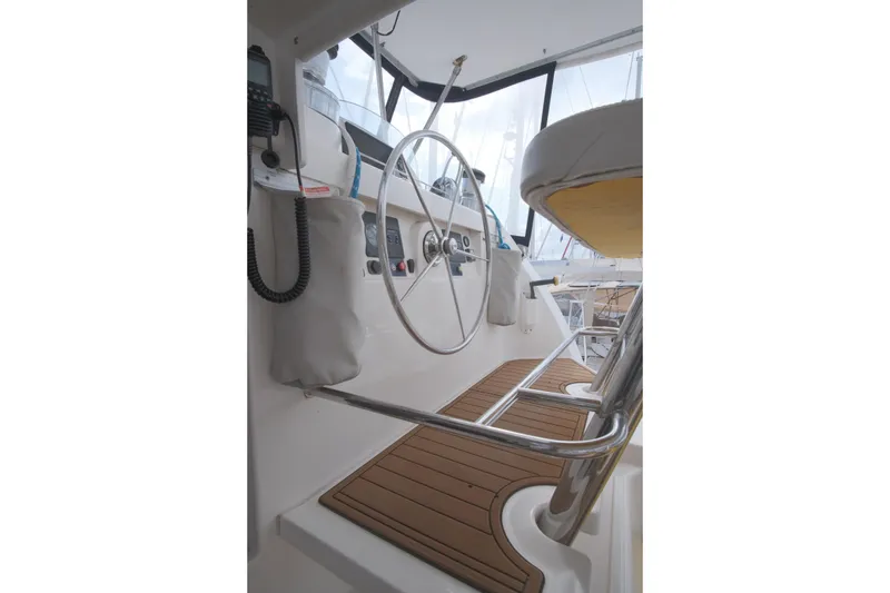Slide: The Image of Helm of 2007 Leopard 46 yacht with wooden flooring and steering wheel. - 59