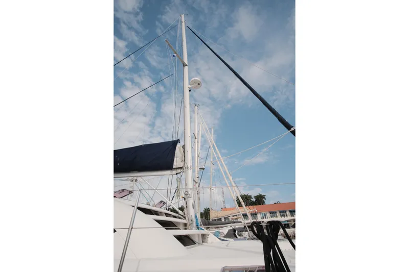 Slide: The Image of Sailboat mast of 2007 Leopard 46 against a blue sky with clouds. - 6