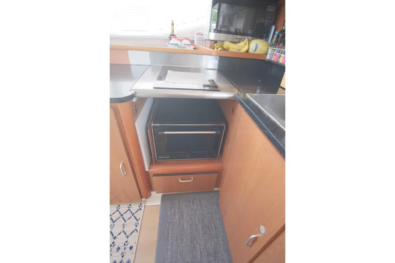 Slide: The Image of Kitchen area in a 2007 Leopard 46 yacht with microwave and countertop. - 60