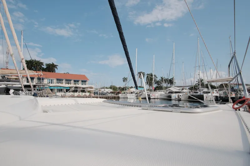 Slide: The Image of Deck view of a 2007 Leopard 46 yacht docked at a marina under a clear blue sky. - 7