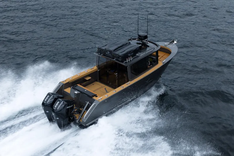 Slide: The Image of 2026 Jasper Marine Defender 22 speeding on open water, showcasing powerful dual engines. - 3