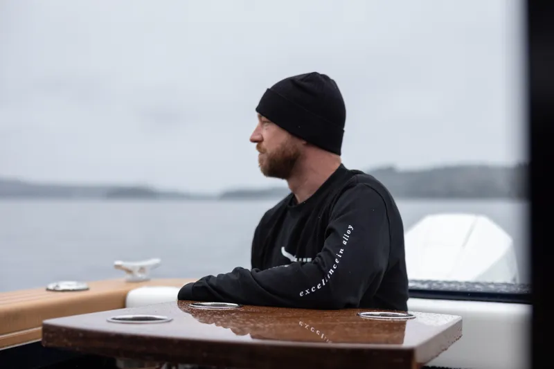 Slide: The Image of Man on Jasper Marine Defender 22 boat, 2026 model, gazing at serene waters. - 8