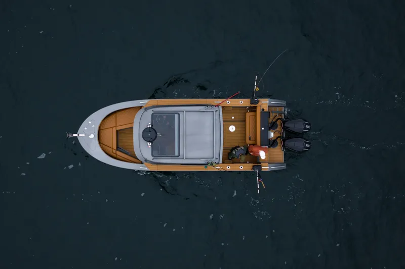 Slide: The Image of Overhead view of 2026 Jasper Marine Defender 22 boat on dark water. - 9