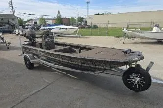 The Image of 2026 Pro-Drive 2060 boat on trailer, parked outdoors in a marina setting. - 1