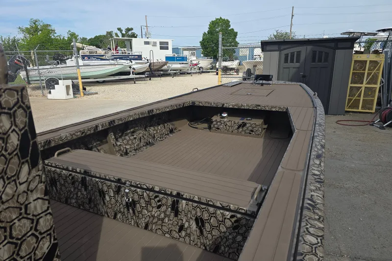 Slide: The Image of 2026 Pro-Drive 2060 boat with camouflage design, parked in a marina storage area. - 12
