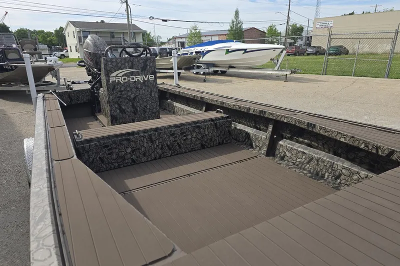 Slide: The Image of 2026 Pro-Drive 2060 boat with camouflage interior, parked outdoors on a sunny day. - 4