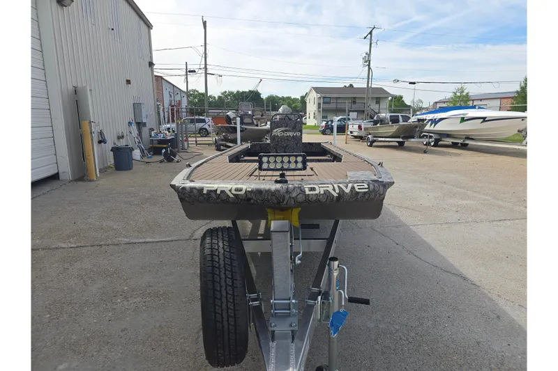 Slide: The Image of 2026 Pro-Drive 2060 boat on trailer in outdoor storage area. - 6