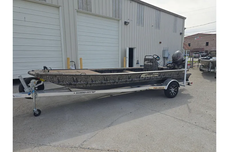Slide: The Image of 2026 Pro-Drive 2060 boat on trailer outside industrial building. - 7