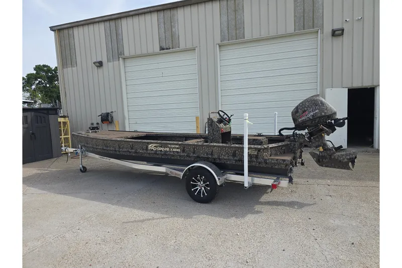 Slide: The Image of 2026 Pro-Drive 2060 boat on trailer, parked outside industrial building. - 8