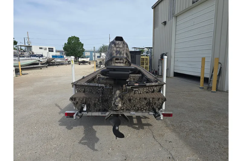 Slide: The Image of 2026 Pro-Drive 2060 boat with camouflage design parked outside a warehouse. - 9