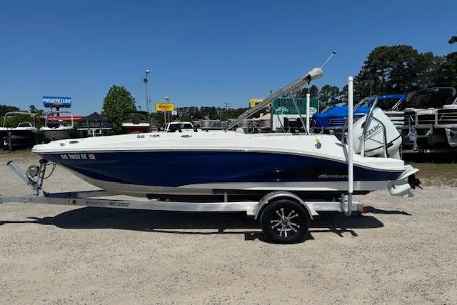 The Image of 2023 Hurricane SunDeck Sport 185 OB boat on trailer, parked outdoors. - 0