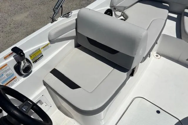Slide: The Image of 2023 Hurricane SunDeck Sport 185 OB boat interior with gray seating and control panel. - 16