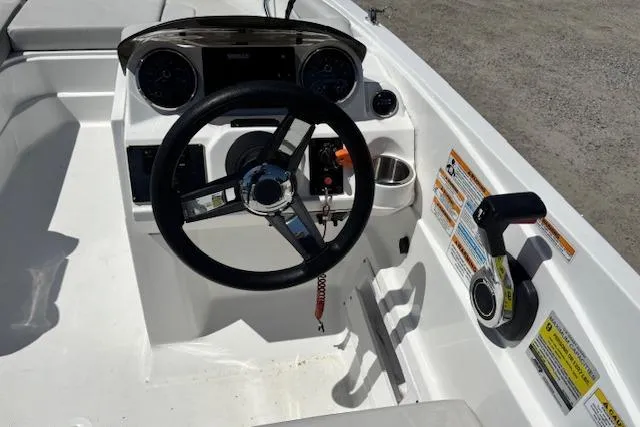 Slide: The Image of 2023 Hurricane SunDeck Sport 185 OB boat cockpit with steering wheel and control panel. - 17