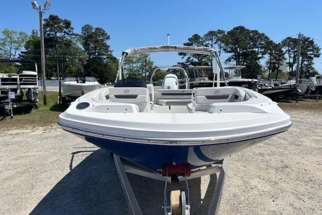 Slide: The Image of 2023 Hurricane SunDeck Sport 185 OB boat on trailer, parked outdoors. - 2