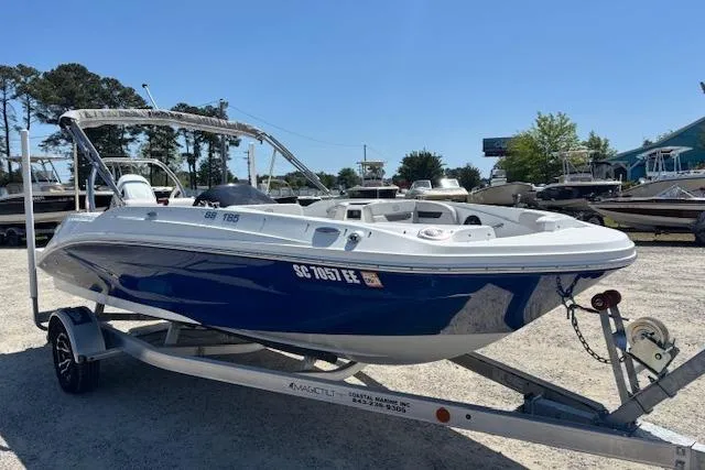 Slide: The Image of 2023 Hurricane SunDeck Sport 185 OB boat on trailer, parked outdoors. - 3