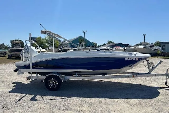Slide: The Image of 2023 Hurricane SunDeck Sport 185 OB boat on trailer, parked outdoors. - 4