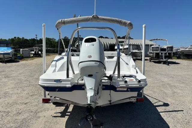 Slide: The Image of 2023 Hurricane SunDeck Sport 185 OB boat with outboard motor, parked on gravel lot. - 6