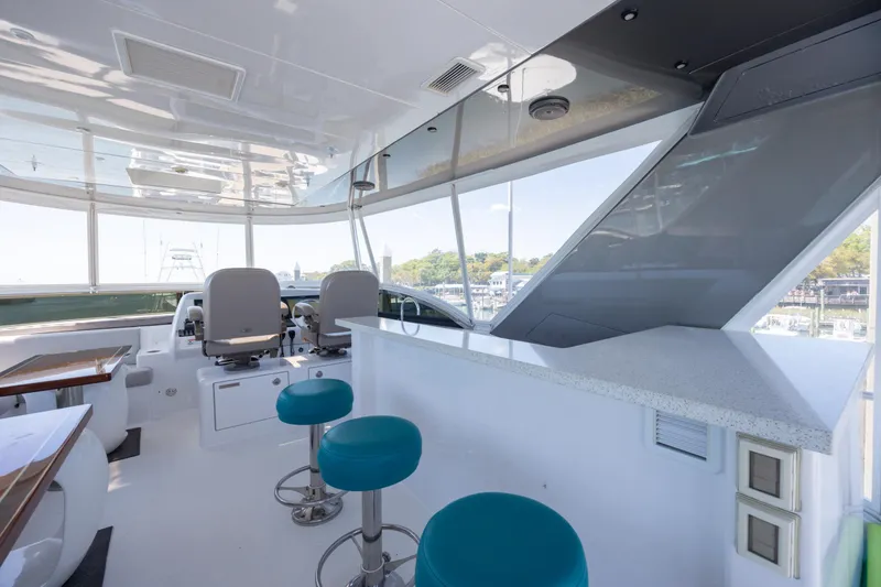 Slide: The Image of Luxurious interior of 2017 Hatteras M75 Panacera yacht with modern seating and helm. - 17