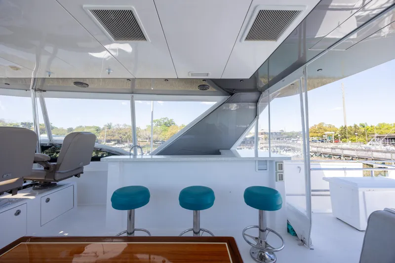 Slide: The Image of Luxurious 2017 Hatteras M75 Panacera yacht interior with bar stools and panoramic windows. - 18