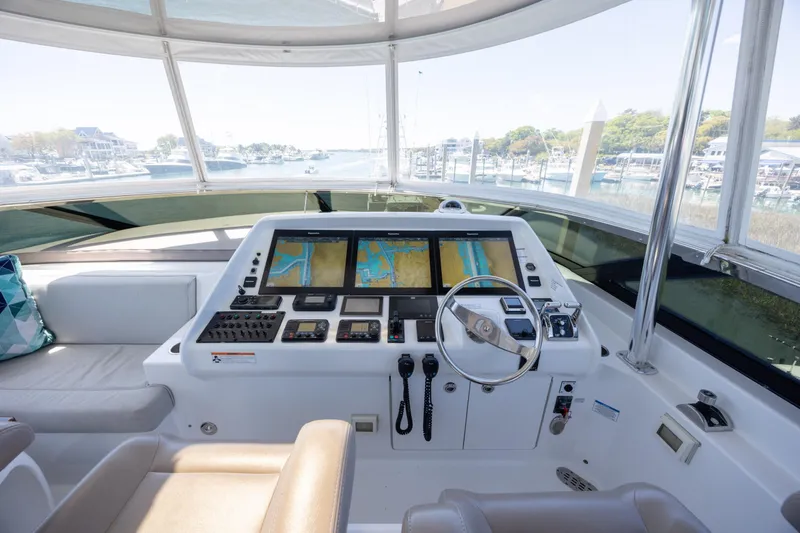 Slide: The Image of Helm of 2017 Hatteras M75 Panacera yacht with navigation screens and steering wheel. - 26