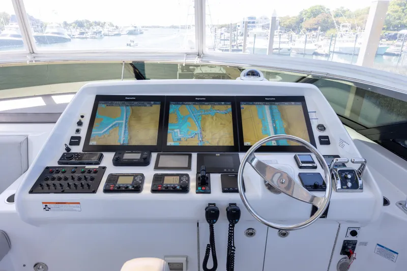 Slide: The Image of Helm of 2017 Hatteras M75 Panacera yacht with navigation screens and controls. - 27
