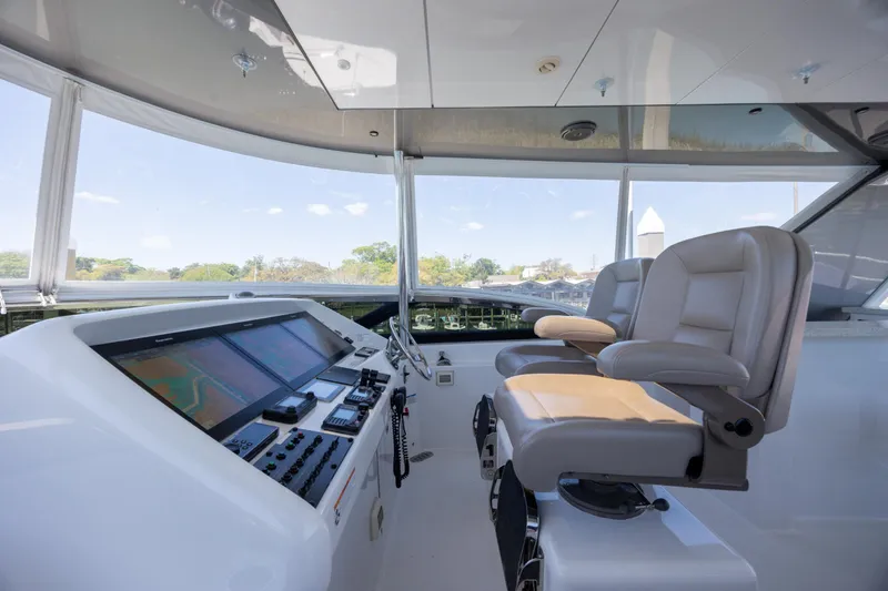 Slide: The Image of Helm of 2017 Hatteras M75 Panacera yacht with modern navigation equipment and comfortable seating. - 29