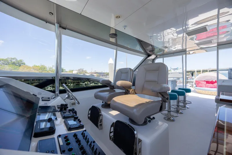 Slide: The Image of Luxurious 2017 Hatteras M75 Panacera yacht helm with modern controls and seating. - 30