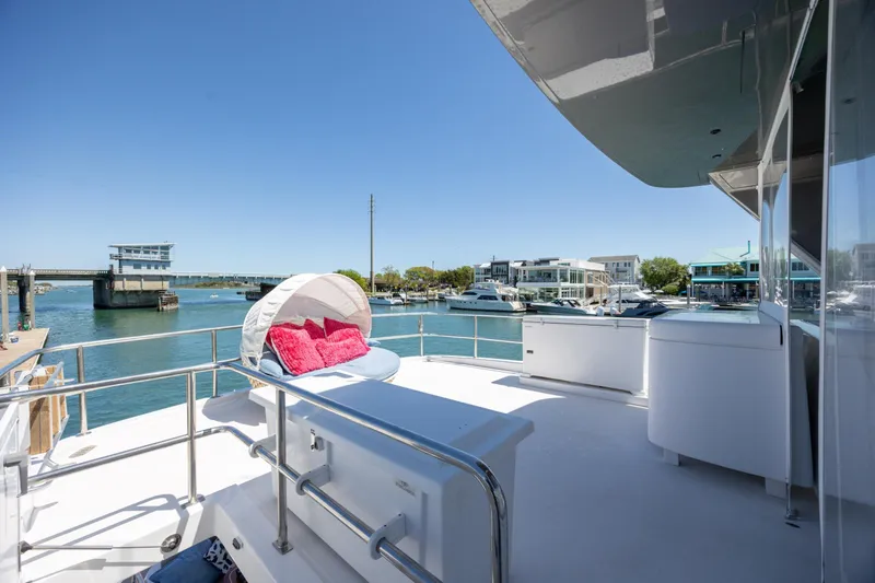 Slide: The Image of Luxurious 2017 Hatteras M75 Panacera yacht deck with waterfront view and sunbed. - 31