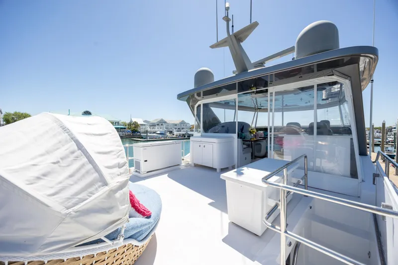 Slide: The Image of Luxurious 2017 Hatteras M75 Panacera yacht deck with seating and marina view. - 32